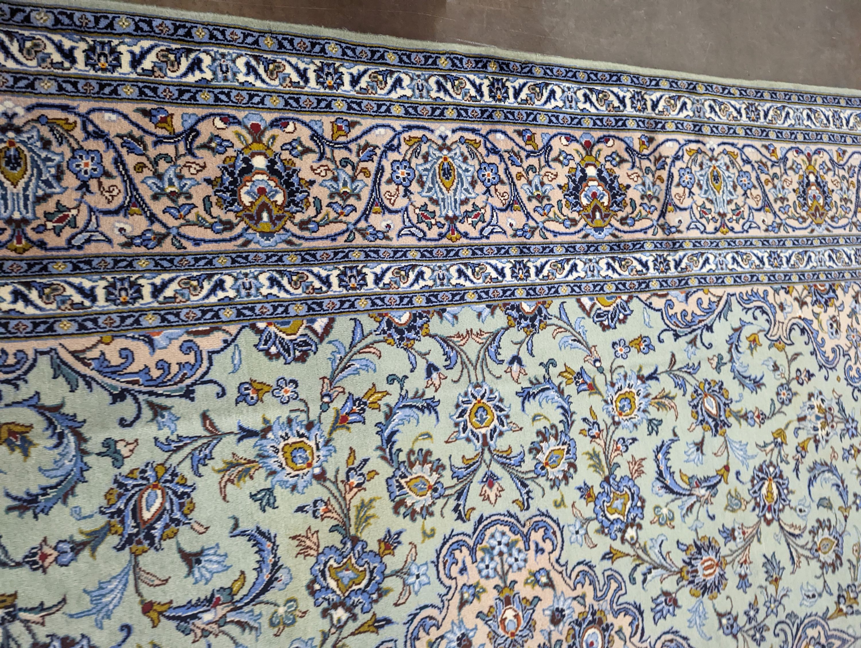 A Kashan pale green ground carpet, 410 x 296cm